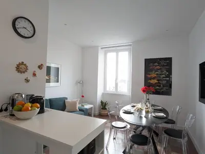 a kitchen and living room with a table and a dining room at Ostiense 353 Apartment by RS in Rome
