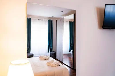 a bedroom with a bed and a large mirror at Vaticano-Cornelia Luxury Home in Rome