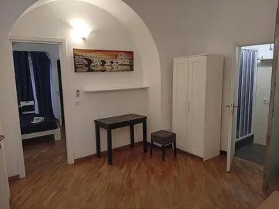 a room with a table and two stools in it at Bilocale privato in Rome