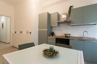 a kitchen with a bowl of fruit on a table at Vigna Clara apartment in Rome