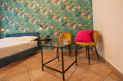 a bedroom with a bed and a glass table and two chairs at RHome 34 in Rome