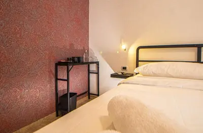 a bedroom with a bed and a side table at RHome 34 in Rome