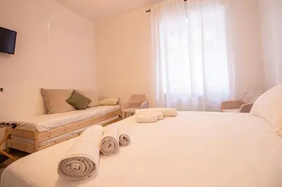 a living room with two beds and a couch at RHome 34 in Rome