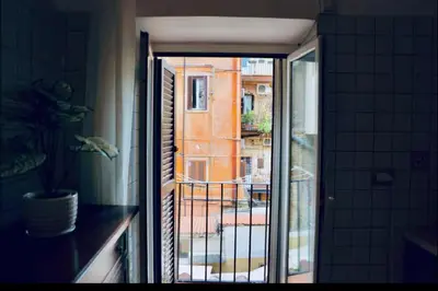 a door to a balcony with a view of a building at Casa di Andrea in Trastevere in Rome