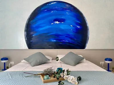 a bed with a large blue painting on the wall at Stellar Stays in Rome