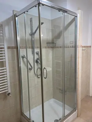 a shower with a glass door in a bathroom at Vatican Time apartment in Rome