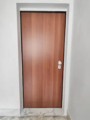 a wooden door in a room with white walls at Rome Cozy Room in Rome