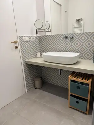 a bathroom with a sink and a mirror at GF Harmony Suite Colosseo in Rome
