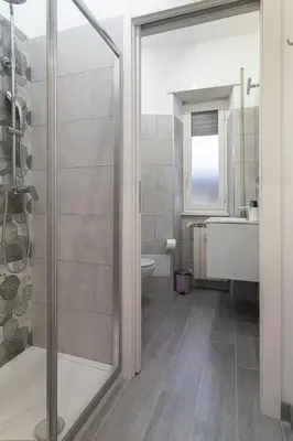a bathroom with a shower and a toilet and a sink at Saulo Boutique Apartment in Rome
