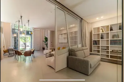 a living room with a couch and a chair and a table at Margutta Spagna Relais in Rome
