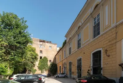 a street with cars parked next to a building at Margutta Spagna Relais in Rome