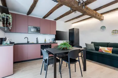 a kitchen and living room with a table and chairs at Rome As You Feel - Trastevere Nest with Secret Patio in Rome