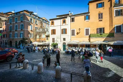 a group of people walking around in a street at Rome As You Feel - Trastevere Nest with Secret Patio in Rome