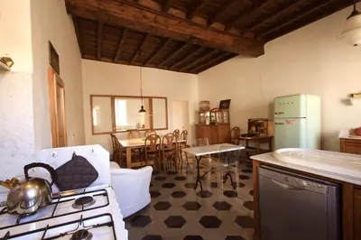 a kitchen with a stove and a dining room at Navona Large 1BR Holiday House in Rome