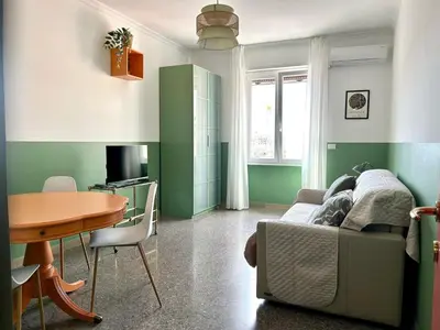 a living room with a table and a couch at Casa Dea Piramide in Rome
