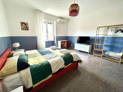 a bedroom with a bed and a ladder and a television at Casa Dea Piramide in Rome
