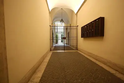 an empty hallway with a gate in a building at Navona Opera Holiday House in Rome