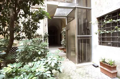 an entrance to a building with plants in a courtyard at Navona Terrace 2BR Holiday House in Rome