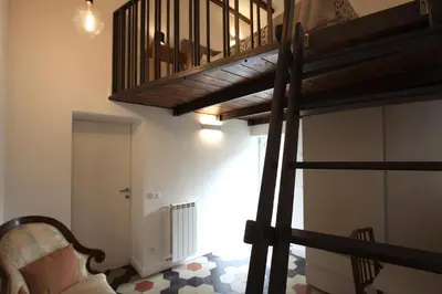 a spiral staircase in a room with a living room at Navona Terrace 2BR Holiday House in Rome