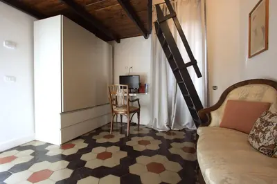 a living room with a couch and a chair at Navona Terrace 2BR Holiday House in Rome