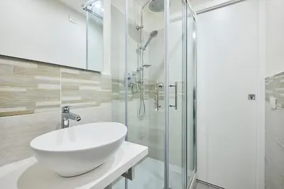 a white bathroom with a sink and a shower at Urban Guesthouse Monti in Rome