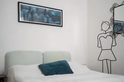 a bedroom with a bed and a picture on the wall at Oasi Tiberina in Rome