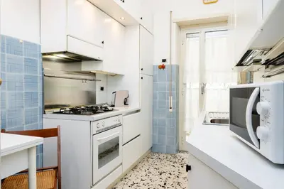 a bedroom with a large white bed with two lamps at La casa dell'artista in Rome