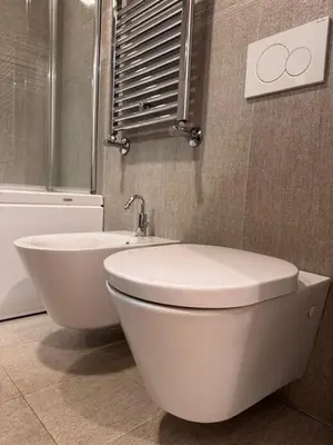 a bathroom with a white toilet and a bath tub at Alberto's panoramic flat in Rome