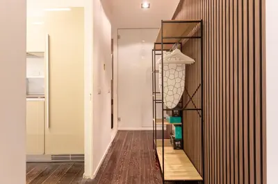 a room with a wooden floor and a black shelf at Cunabu Sardegna in Rome