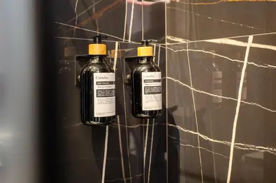 two bottles of alcohol are hanging on a wall at Cunabu Sardegna in Rome