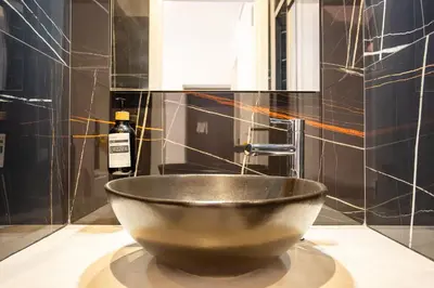 a bowl on a counter with a bottle of wine at Cunabu Sardegna in Rome
