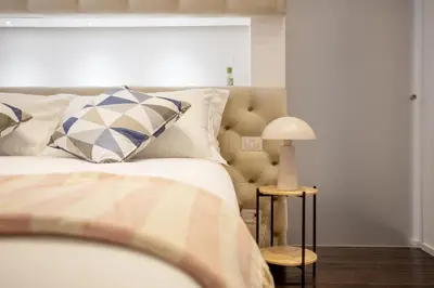 a bedroom with a bed and a lamp on a table at Cunabu Sardegna in Rome