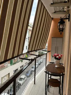 a balcony with a table and a vase of flowers on it at RenMa Caffarella House in Rome