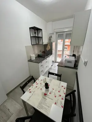 a kitchen with a table and chairs and a kitchen with a counter at RenMa Caffarella House in Rome
