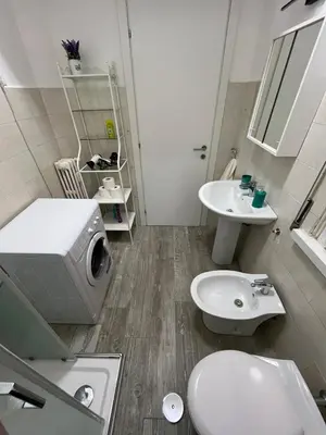a bathroom with a toilet and a sink at RenMa Caffarella House in Rome