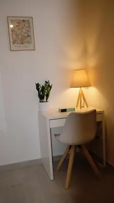 a desk with a chair and a lamp on it at Augusto's House b&b in Rome