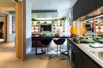 a kitchen with a counter and stools in it at Fabiolous suites in Rome