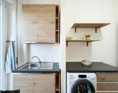a kitchen with a sink and a washing machine at La Casa di EDY - Metro Malatesta in Rome