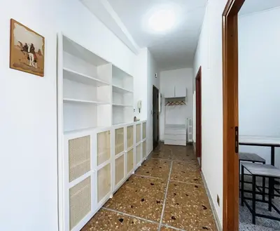 a hallway with white walls and white shelves at La Casa di EDY - Metro Malatesta in Rome