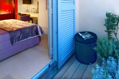 a door to a room with a bed and a trash can at Domus Adriani in Rome