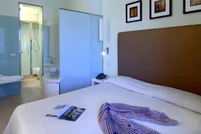 a bedroom with a bed with a book on it at Domus Adriani in Rome