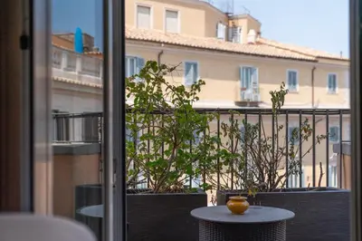 a table with a vase sitting on top of a balcony at Domus Adriani in Rome