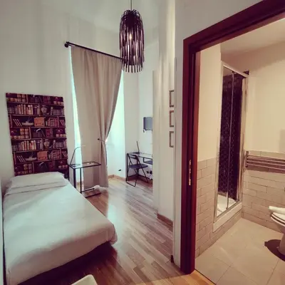 a bedroom with a bed and a large mirror at Rome Center Rooms in Rome