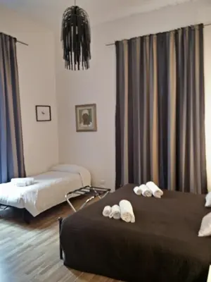 a hotel room with two beds with towels on them at Rome Center Rooms in Rome