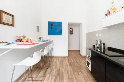 a kitchen with a counter and stools at Rome Center Rooms in Rome