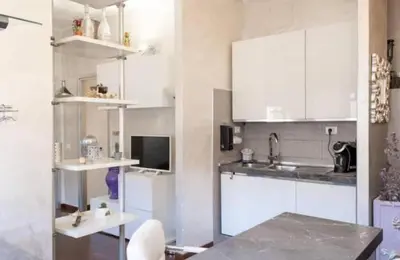 a kitchen with white cabinets and a sink at Roma Centro appartamento in Rome