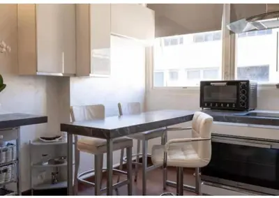 a kitchen with a table with chairs and a microwave at Roma Centro appartamento in Rome