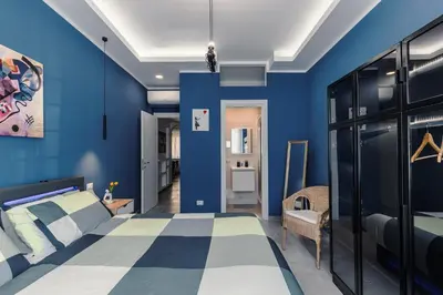 a bedroom with blue walls and a bed at OASIS Of PEACE CLOSE TO VATICANO in Rome