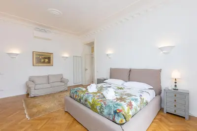 a bedroom with a large bed and a couch at Amazing Piazza Fiume in Rome