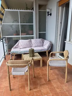 a table and two chairs and a bench on a porch at la casa di Janis in Rome